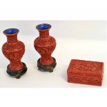 Chinese red lacquer box with carved floral design, together with two similar baluster shaped vases