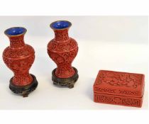 Chinese red lacquer box with carved floral design, together with two similar baluster shaped vases