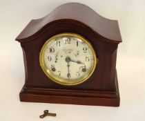 Mahogany cased Seth Thomas Sonora chiming mantel clock with silvered dial and arched top, 24cms high