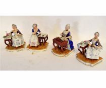 Group of four 19th century Continental figures of seated ladies with blue and gilded overcoats, to