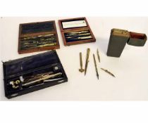 Two vintage teak cased sets of drawing instruments and a vintage green case containing mixed brass