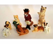 Six Royal Doulton models of miniature dogs, together with a further Royal Doulton model of a cat