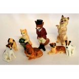 Six Royal Doulton models of miniature dogs, together with a further Royal Doulton model of a cat