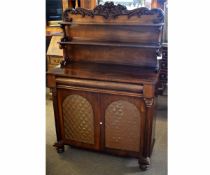 Regency rosewood chiffonier with carved back and two open shelves with scrolling supports, the