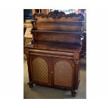 Regency rosewood chiffonier with carved back and two open shelves with scrolling supports, the