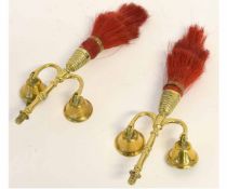 Pair of brass harness mounts with two arms supporting bells and red plume