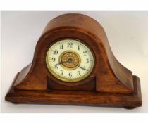 Early 20th century oak cased mantel clock with enamelled dial, raised on bun feet, 27cms wide x