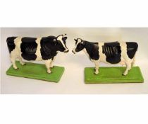 Good quality pair of models of a Holstein-Friesian true type cow on a green base, each 29cms wide