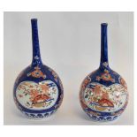 Pair of Japanese late 19th century blue ground vases with panels with polychrome decoration, the