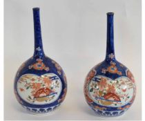 Pair of Japanese late 19th century blue ground vases with panels with polychrome decoration, the