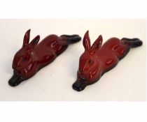 Two Royal Doulton flambe models of reclining rabbits, each 10cms long