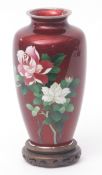 Japanese cloisonne and gin bari enamel vase decorated with roses against a translucent ruby red