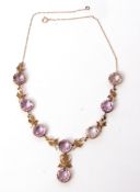 Early 20th century amethyst riviere necklace, the circular-shaped amethysts each in coronet shaped