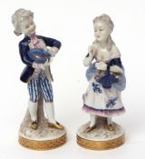 Pair of Continental porcelain figures of a boy and a girl, decorated predominantly in blue and white