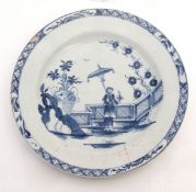 Rare Lowestoft plate, circa 1765, decorated with the lady and parasol pattern standing by a fence,