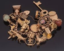 9ct gold charm bracelet suspending one full and one half gold sovereign, various other charms to