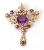 Antique openwork amethyst and seed pearl brooch having a centrally set oval amethyst, the foliate