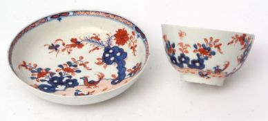 Lowestoft tea bowl and saucer, circa 1780, painted in blue and iron red with the two bird pattern,