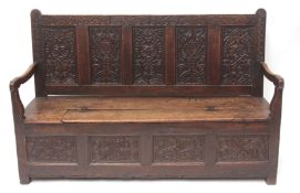 Oak settle with four panelled carved back and cresting rail, bears initials and date RST 1649,