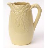Large yellow ground Clarice Cliff jug with moulded floral design to the top, 28cms high