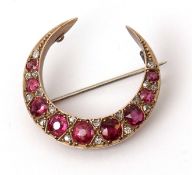 Antique ruby and diamond crescent brooch set with nine graduated rubies interspersed with 18 old cut