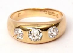 18ct gold three-stone diamond ring, the three old cut graduated diamonds in rub-over settings,