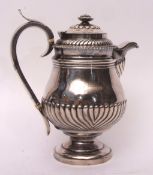 Late George III hot water pot of baluster form with hinged and domed cover and bladed finial, with