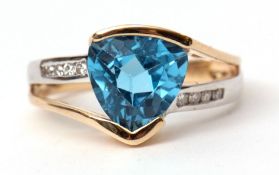Two-tone precious metal blue topaz and diamond ring, the trillium cut blue topaz raised between