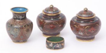 Four pieces of Japanese cloisonne enamel comprising a pair of jars and covers, a vase and a napkin