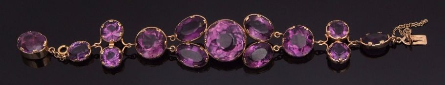 9ct gold and amethyst coloured glass cluster bracelet, having a circular and oval cut graduated