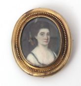 Victorian oval framed portrait brooch depicting a hand painted head and shoulders of a lady, set