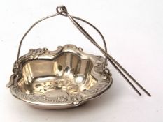 Early 20th century American tea strainer, the shaped basket with C-scroll and foliate design and