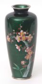 Japanese cloisonne and gin bari enamel vase decorated with a spray of prunus blossom against a