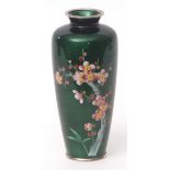 Japanese cloisonne and gin bari enamel vase decorated with a spray of prunus blossom against a