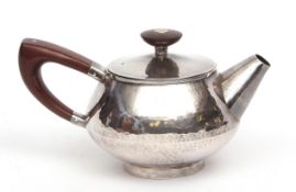 Elizabeth II bachelor's teapot, the spot hammered body with pull off cover fitted with a bladed