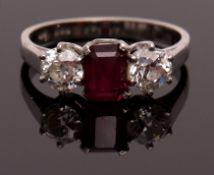 Ruby and diamond three-stone ring, the central rectangular ruby, approx 7 x 5mm, claw set between