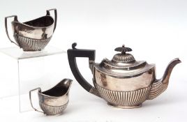 Edward VII bachelor's three piece tea set of half fluted oval form and comprising tea pot, sugar