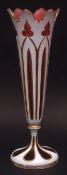 Overlaid glass spill vase with everted pointed rim, overlaid in white with gilded detail