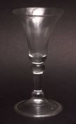 18th century small balustroid stem wine glass with spreading circular folded foot, 13 1/2cms high