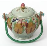 Clarice Cliff biscuit barrel and cover decorated with Autumn leaves and berries on a green ground,