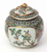 Small Chinese porcelain jar and cover decorated in famille vert enamels, with panels of figures in