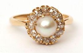 Antique pearl and diamond cluster ring featuring a single cultured pearl surrounded by 12 small