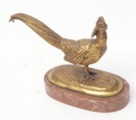Late 19th/early 20th century gilt brass model of a golden pheasant on an oval base with variegated
