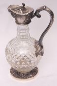 20th century white metal mounted and clear cut glass claret jug of baluster form with faceted