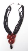Lalique red serpent crystal necklace, etched on the back "Lalique 50/188", suspending a faceted