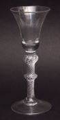 Conical bowl wine glass with balustroid air twist stem on spreading circular foot, 17 1/2cms high