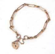 9ct gold bracelet having oval links with rope twist design connectors to a heart padlock and