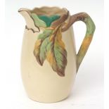 Large cream coloured jug with moulded leaf pattern, 24cms high