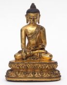 Small Oriental gilt bronze of a seated Buddha upon a lotus base, the base plate present but at