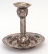 Edward VII Art Nouveau style single candlestick, the hammered and stepped circular saucer base set